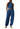 Woman wearing a blue striped jumpsuit on a white background