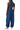 Woman wearing a blue striped jumpsuit on a white background