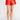 Red satin skirt worn by a person on a white background