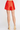 Red shorts worn by a person on a white background