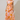 Woman wearing a floral dress with orange and pink pattern on a plain background