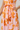 Floral dress with orange and pink pattern on a white background