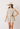 Woman wearing a floral dress and straw hat with colorful band on a white background