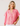 Woman wearing a pink and red striped shirt against a plain background