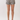 A model from the waist down wearing high-waisted shorts with a black and white zebra print, paired with beige heeled sandals, against a plain light background.