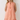 WOMAN WEARING AN ORANGE GINGHAM SHIFT DRESS.