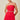 Woman wearing a red strapless dress with a beige background