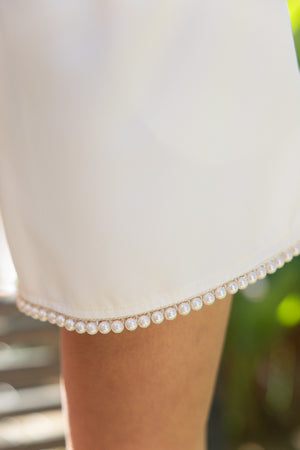 CARLY PEARL TRIMMED HEM PLEATED SHORTS IN IVORY