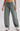 Green wide-leg pants worn by a person on a white background