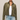 A woman modeling a cropped, long-sleeve button-front overshirt in olive green suede-like fabric, worn over a white tank top and light-wash blue jeans against a plain light beige studio background.