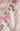 Close-up of a fabric with pink floral pattern on a white background