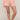 Person wearing pink textured pajama set on a plain background