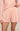 Pink pajama set with floral pattern on a beige background