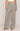 Plaid pajama pants worn by a person on a plain background