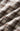 A close-up of a draped plaid fabric with a warm brown, cream, and light blue checkered pattern.