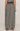 Person wearing a black and white checkered skirt on a beige background
