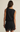 Black sleeveless dress with lace details on a beige background