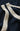 Close-up of a navy blue garment with beige lace trim