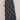 A navy blue plaid maxi skirt with a diagonal tartan pattern in white and gray, styled with a beige knit sweater and brown suede ankle boots against a light gray studio background.