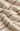 Close-up of a textured beige fabric with wavy lines