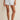 Person wearing light blue and white striped shorts on a beige background