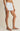 Person wearing light blue and white striped shorts on a beige background