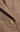 Close-up of a brown and beige houndstooth patterned jacket with a single visible button.