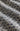 A close-up of a fabric with a dense navy blue floral or floral-like print on a warm off-white or cream background, showing soft folds and texture.
