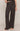 Person wearing black wide-leg pants on a plain background