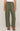 Person wearing olive green cargo pants on a plain background