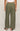 Person wearing olive green wide-leg pants on a plain background