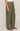 Person wearing olive green cargo pants on a plain background