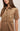 Brown suede dress worn by a model on a plain background