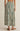 Long floral skirt with green pattern on a neutral background