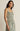 Woman wearing a floral dress against a beige background