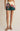 Woman wearing a floral skirt with a plain background