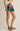 Person wearing a floral skirt with a neutral background