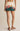 Person wearing a floral mini skirt on a plain background