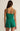 Green romper worn by a person on a beige background