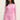 Woman wearing pink pajama set on a beige background