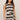 Woman wearing a black and white striped dress on a beige background