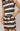 Black and white striped dress worn by a person on a plain background