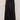 Person wearing a black long skirt on a plain background