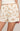 Shorts with animal and plant pattern worn by a person on a neutral background