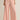 Person wearing light pink wide-leg pants on a beige background
