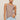 Woman wearing a brown tank top and light blue jeans against a beige background