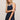 Woman wearing a navy dress with white trim against a beige background
