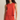 Woman wearing a red sleeveless top and pants against a beige background