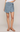 Person wearing a blue wrap skirt on a plain background