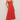Woman wearing a strapless red dress on a plain background